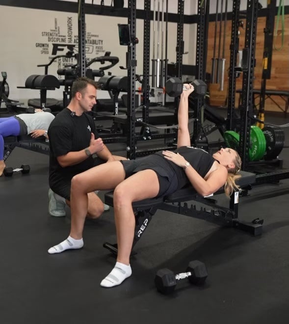 Coach Miles coaching the single arm bench press
